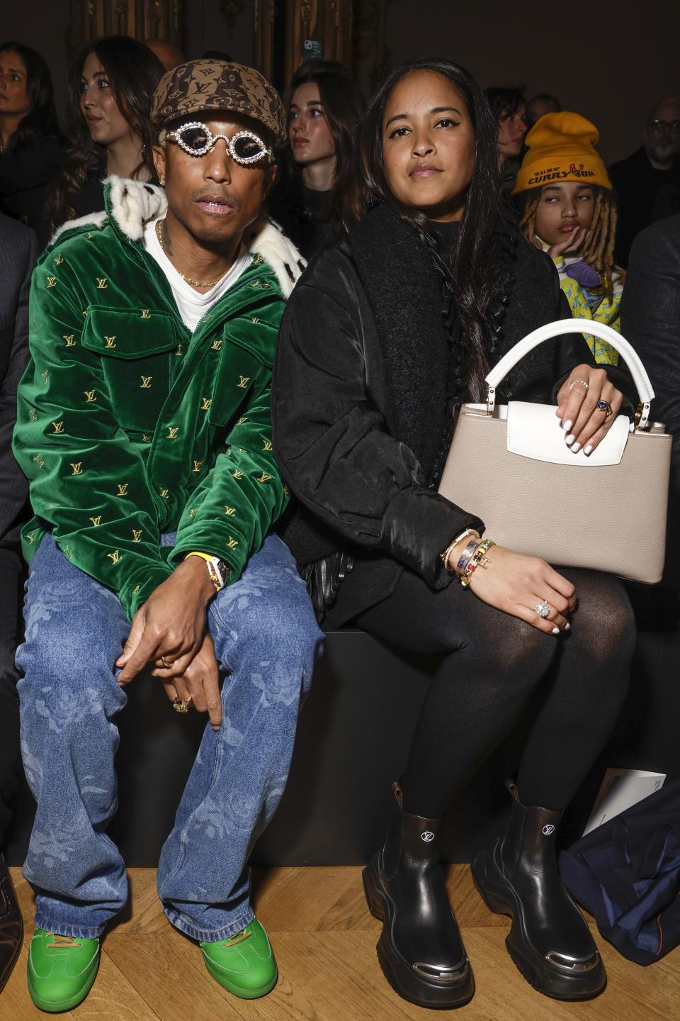 Pharrell Williams, left, and Helen Lasichanh attend the Louis Vuitton Fall/Winter 2023-2024 ready-to-wear collection presented Monday, March 6, 2023 in Paris. (Vianney Le Caer/Invision/AP)