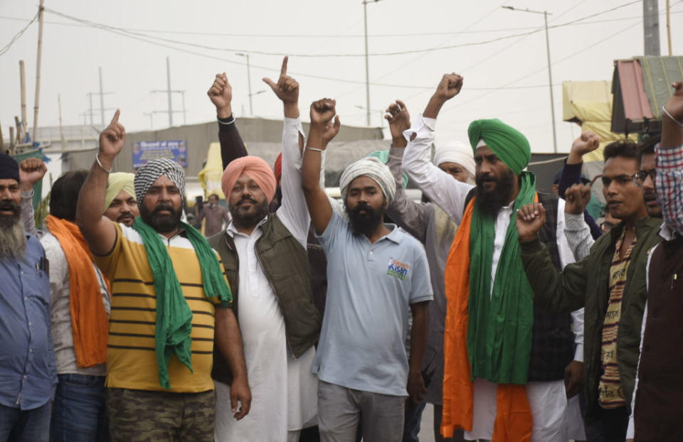 Farmers celebrate after Prime Minister Narendra Modi announced the repeal of new farm laws, on Nov. 19, 2021, in Ghaziabad, Uttar Pradesh, India<span class="copyright">Sakib Ali/Hindustan Times via Getty Images</span>