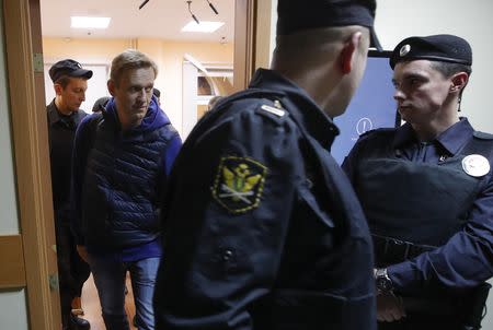 Russian opposition leader Alexei Navalny (2nd L), who was detained over allegations of staging illegal protests and sentenced to 20 days in jail, walks inside a court building in Moscow, Russia September 24, 2018. REUTERS/Maxim Shemetov