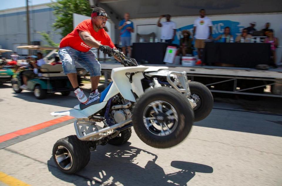 A rider with Bikes Up Guns Down rode past the judges stand at the JuneteenthKC 2021 Cultural Parade Saturday, June 12, 2021 in the Historic Jazz District near 18th and Vine.