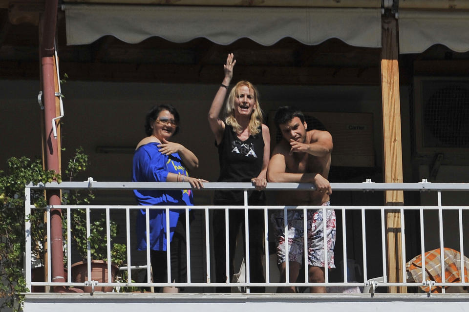 People in apartments adjacent to a voting station heckled Socialist leader Evangelos Venizelos, shouting slogans such as "Thieves Out!" in Thessaloniki, northern Greece Sunday May 6, 2012. Greeks cast ballots on Sunday in their most critical _ and uncertain _ election in decades, with voters set to punish the two main parties that are being held responsible for the country's dire economic straits. (AP Photo/Nikolas Giakoumidis)