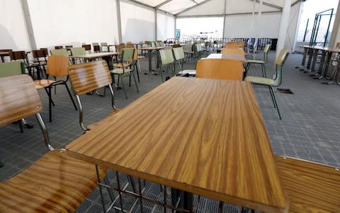 Tables are set inside a Red Cross tent installed at Valencia's harbour for the reception of migrants rescued by the Aquarius rescue ship  - Credit: AFP