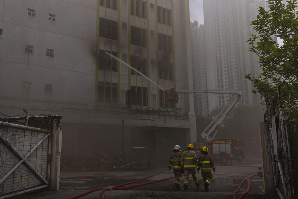 Firefighters battle a fire in Cheung Sha Wan, a residential and industrial area, in Hong Kong, Friday, March 24, 2023. Hong Kong firefighters were battling a blaze Friday at a warehouse that forced more than 3,000 people to evacuate, including students, police said. (AP Photo/Louise Delmotte)