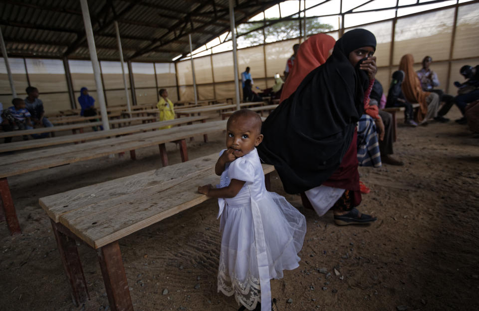 FILE - In this Tuesday, Dec. 19, 2017 file photo, some of around 20 Somali refugee families wait to be flown to Kismayo in Somalia, under a voluntary repatriation programme, at the airstrip of Dadaab refugee camp, hosting over 230,000 inhabitants, in northern Kenya. An internal United Nations document obtained by The Associated Press on Friday, March 29, 2019 says Kenya again seeks to close the Dadaab camp that hosts more than 200,000 refugees from neighboring Somalia. (AP Photo/Ben Curtis, File)