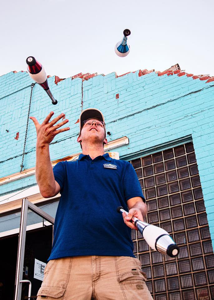 Jason Hedden juggles on the sidewalk off Beck Avenue during Art Break Day 2019.