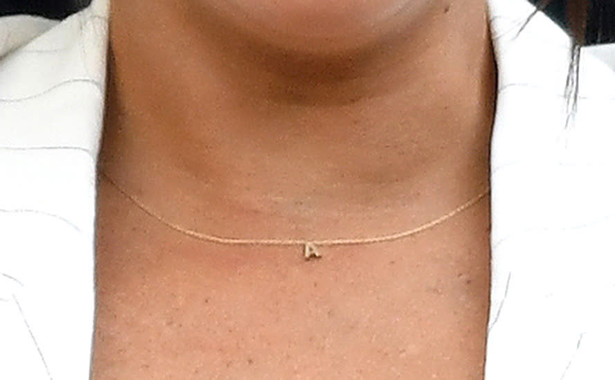 Close up of Meghan Markle wearing an Australian designed 'a' necklace for Archie at Wimbledon 