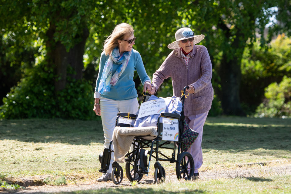 Former nurse Joan Rich, 101, walks through Allenby Park in Felixstowe, Suffolk, to raise money for NHS Charities Together. Mrs Rich, who uses a frame to aid her walking, aims to walk 102 laps of the park before her 102nd birthday on 11 September. (Photo by Joe Giddens/PA Images via Getty Images)