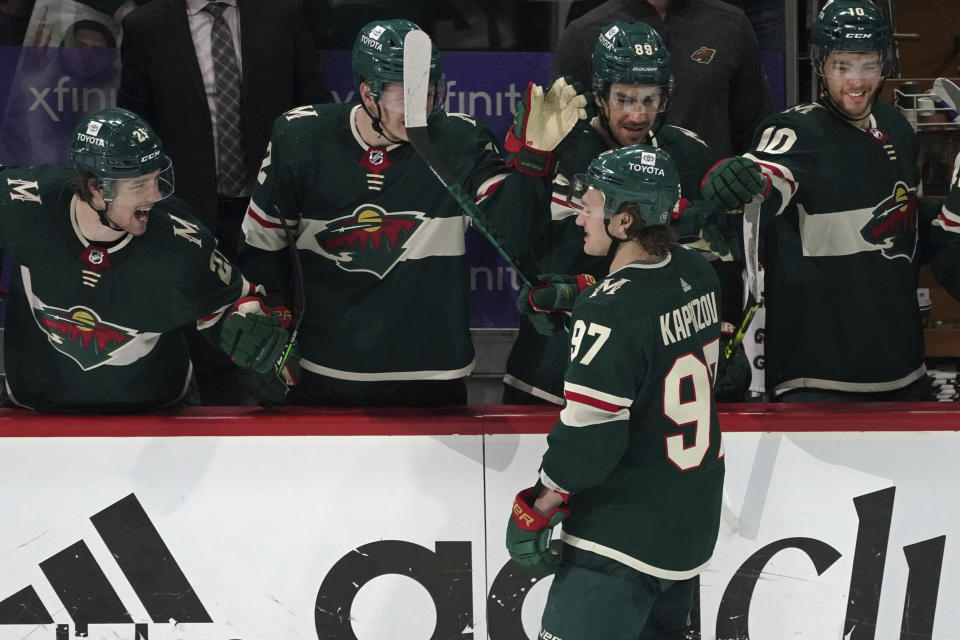 Minnesota Wild's Kirill Kaprizov (97) is greeted at the bench after he scored his third goal of the night against the St. Louis Blues, during the third period of Game 2 of an NHL hockey Stanley Cup first-round playoff series Wednesday, May 4, 2022, in St. Paul, Minn. The Wild won 6-2. (AP Photo/Jim Mone)