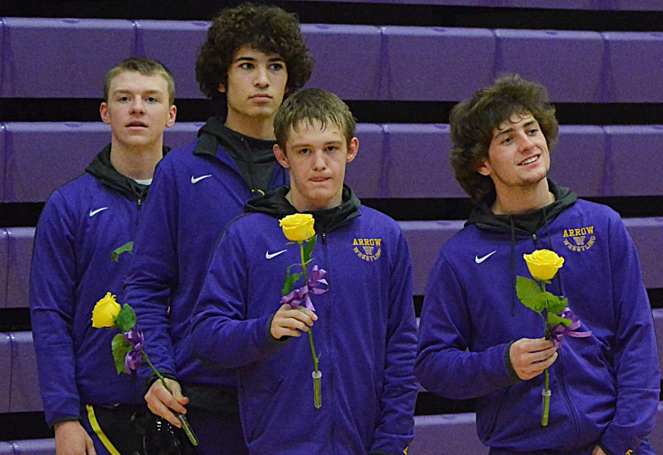 Senior wrestlers, from left, Tucker Urdahl, Andrew Stricker, Sloan Johannsen and Derek Hanson hold flowers for their mothers on Senior Night for Watertown High School's wrestling teams prior to Eastern South Dakota Conference duals against Brookings on Thursday, Dec. 14, 2023 in the Civic Arena.
