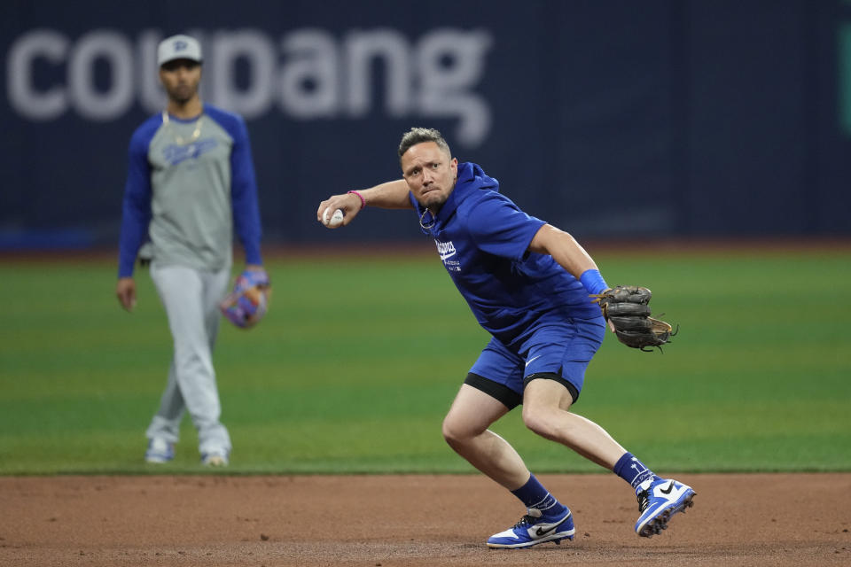 Los Angeles Dodgers' Miguel Rojas fields a ground ball during a baseball workout at the Gocheok Sky Dome in Seoul, South Korea, Tuesday, March 19, 2024. (AP Photo/Lee Jin-man)