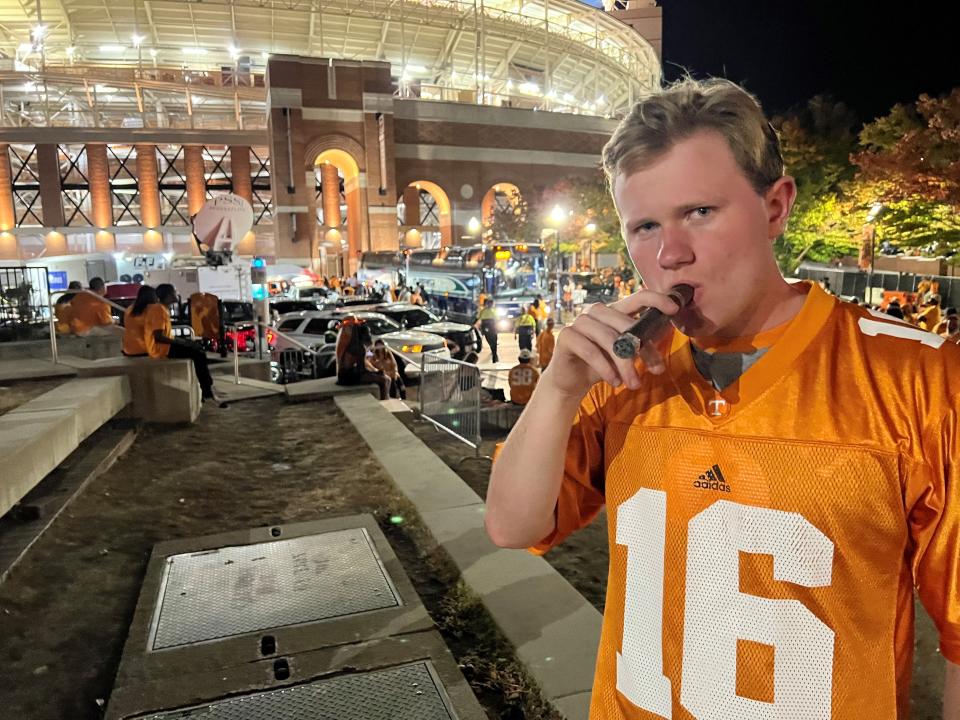 Tennessee fan Eli Sparks enjoys his first cigar outside Neyland Stadium after the Vols upset Alabama 52-49 on Oct. 15, 2022.