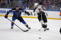 Arizona Coyotes' Phil Kessel (81) and St. Louis Blues' Marco Scandella (6) chase after a loose puck during the third period of an NHL hockey game Monday, April 4, 2022, in St. Louis. (AP Photo/Jeff Roberson)