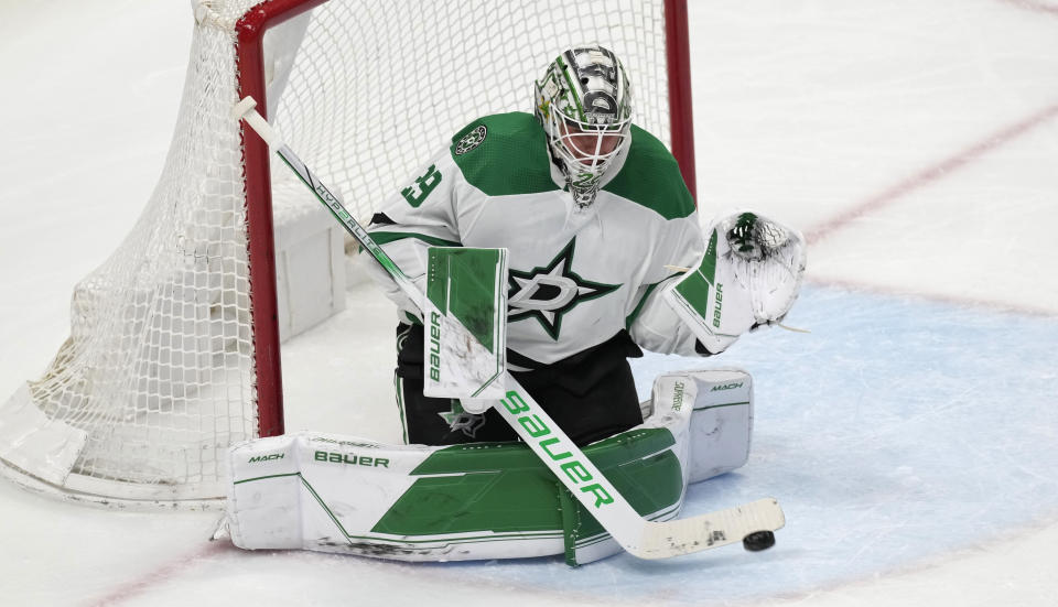 Dallas Stars goaltender Jake Oettinger makes a stick-save in the third period of an NHL hockey game against the Colorado Avalanche, Saturday, April 1, 2023, in Denver. (AP Photo/David Zalubowski)