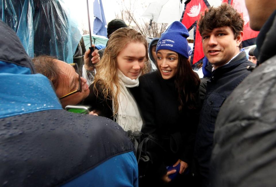 <div class="inline-image__caption"><p>Rep. Alexandria Ocasio-Cortez (D-NY) talks with a man in the crowd as she squeezes between her Deputy Communications Director Anika Legrand-Wittich (L) and her Communications Director Corbin Trent (R).</p></div> <div class="inline-image__credit">Jim Bourg/Reuters</div>