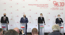 Slovak Foreign Minister Ivan Korcok, left, Polish Foreign Minister Zbigniew Rau, Hungarian Foreign Minister Peter Szijjarto and Czech Republic Foreign Minister Tomas Petricek, right, attend a press conference after the foreign ministers of the Visegrad Group ,V4, in Lodz, Poland, Friday, May 14, 2021.(AP Photo/Czarek Sokolowski)