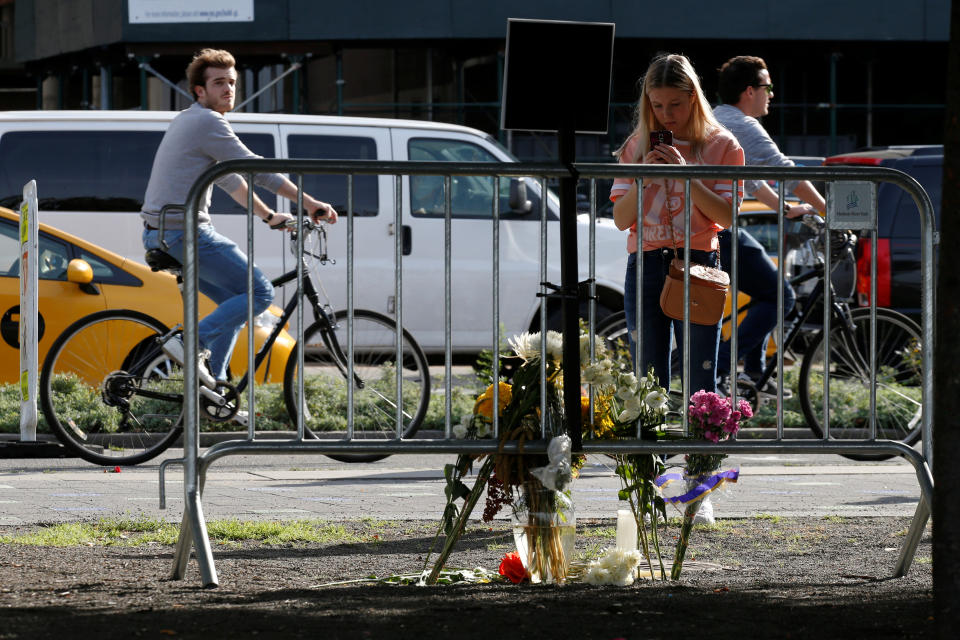 People stop to look at makeshift memorials along a bike path in honor of the attack victims, Nov. 3, 2017. 