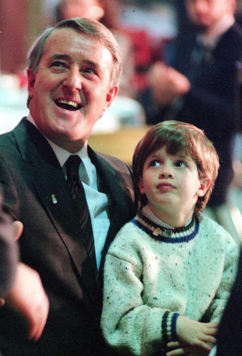 Prime Minister Brian Mulroney smiles with his youngest child Nicolas, five-years-old, on his lap during a luncheon speech in Buckingham, Que., Sunday, Dec. 16, 1990. (CP PHOTO/Fred Chartrand)