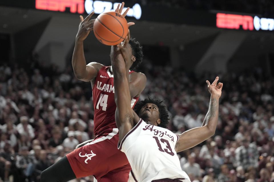 Texas A&M forward Solomon Washington (13) fights for rebound with Alabama center Charles Bediako (14) during the first half of an NCAA college basketball game Saturday, March 4, 2023, in College Station, Texas. (AP Photo/Sam Craft)