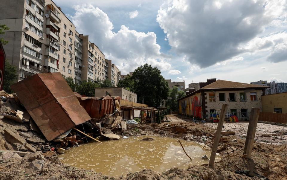 A crater in the grounds of a kindergarten after the strike - Valentyn Ogirenko/Reuters 