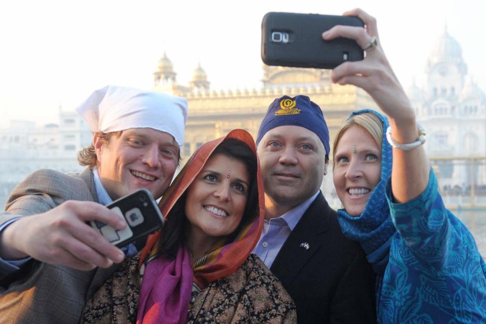 Haley with her husband Michael, second right, and officials at the Golden Temple in Amritsar, 2014 (AFP via Getty Images)