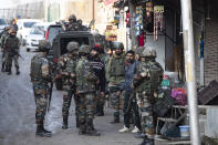 Indian security officers interrogate civilians near the site of an attack on the outskirts of Srinagar, Indian controlled Kashmir, Thursday, Nov. 26, 2020. Anti-India rebels in Indian-controlled Kashmir Thursday killed two soldiers in an attack in the disputed region’s main city, the Indian army said.(AP Photo/Mukhtar Khan)