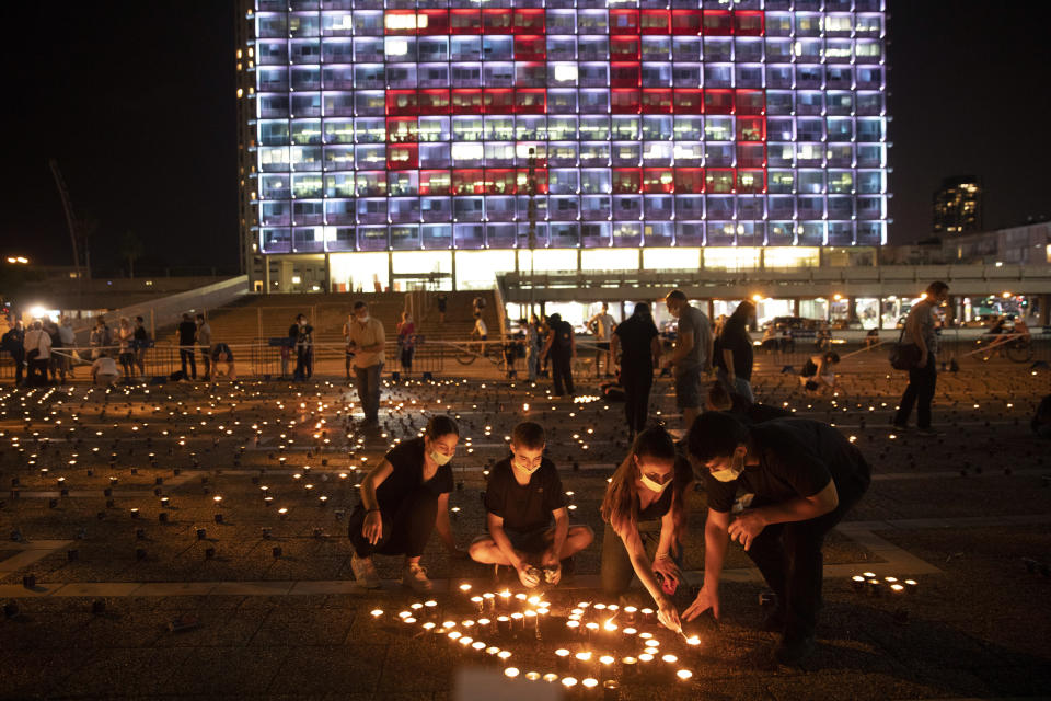 Israelis light memorial candles on the 25th anniversary of the assassination of Israeli Prime Minister Yitzhak Rabin, at Rabin Square, Tel Aviv, Israel, Thursday, Oct. 29, 2020. (AP Photo/Oded Balilty)