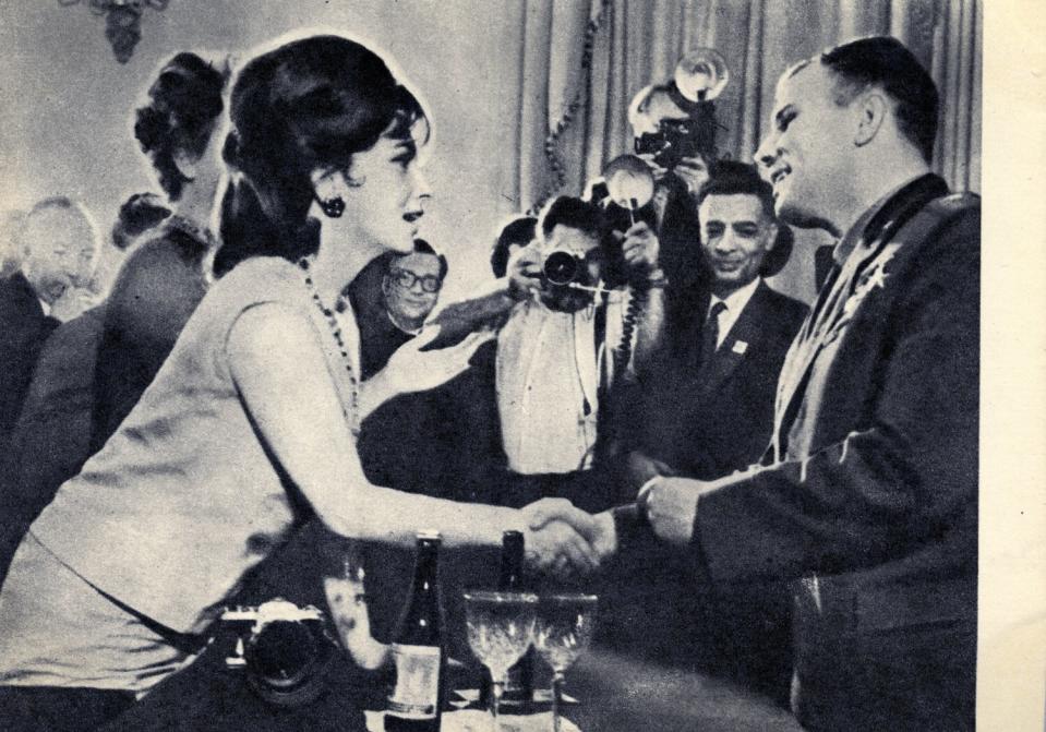 Gagarin is congratulated by Italian movie star Gina Lollobrigida. The caption wonders: "A man who has been in space! What is he like? Hundreds of thousands of people rush to shake his hand, offer him good wishes."