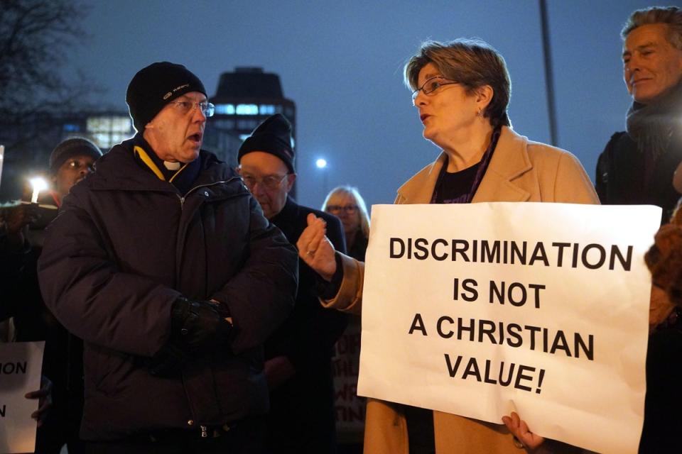 The Archbishop of Canterbury Justin Welby, left, speaks with Jayne Ozanne, right, and other LGBT+ campaigners and their allies (Yui Mok / PA)