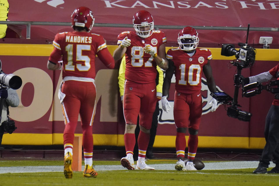 Kansas City Chiefs tight end Travis Kelce (87) celebrates his 20-yard touchdown reception with Patrick Mahomes (15) Tyreek Hill (10) in the second half of an NFL football game against the Denver Broncos in Kansas City, Mo., Sunday, Dec. 6, 2020. (AP Photo/Jeff Roberson)