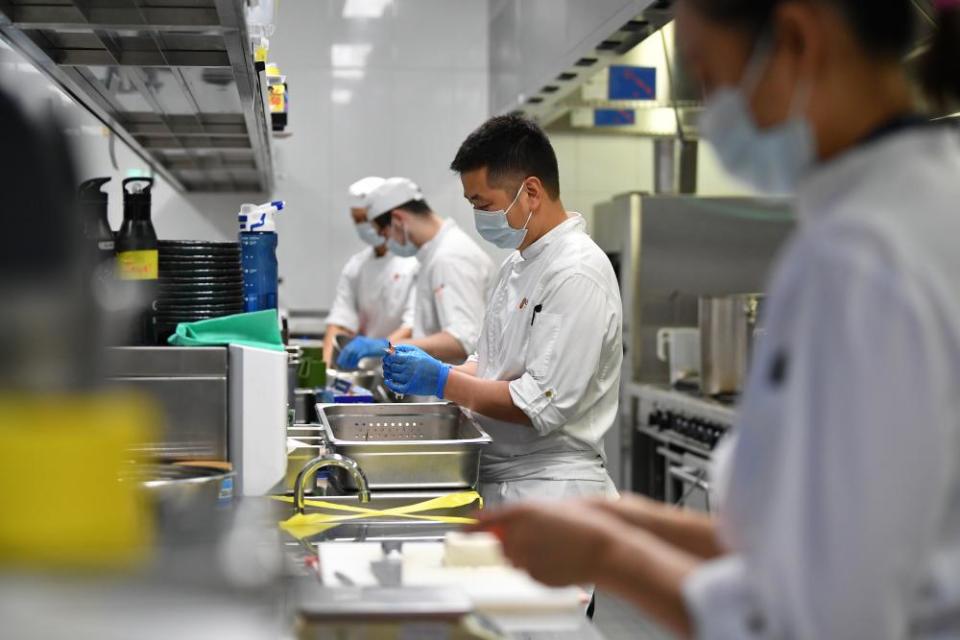 Workers prepare food at Japanese restaurant Nobu at Crown Sydney