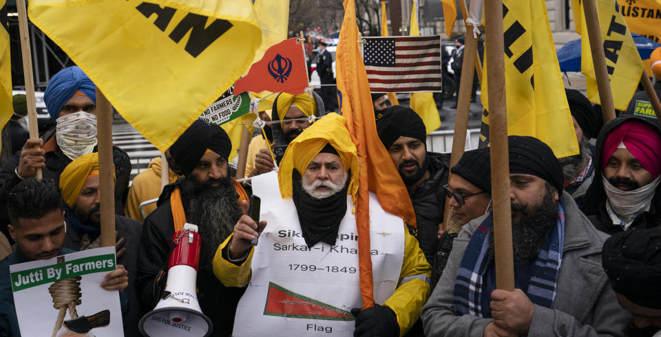 Protesters gather on Fifth Avenue after NYPD officer closed down the street outside the Consulate General of India, Tuesday, Jan. 26, 2021, in the Manhattan borough of New York. Tens of thousands of protesting farmers have marched, rode horses and drove long lines of tractors into India's capital, breaking through police barricades to storm the historic Red Fort. The farmers have been demanding the withdrawal of new laws that they say will favor large corporate farms and devastate the earnings of smaller scale farmers. Republic Day marks the anniversary of the adoption of India’s constitution on Jan. 26, 1950. (AP Photo/John Minchillo)