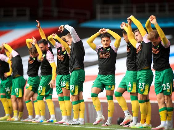 Norwich warming up at the Emirates Stadium (EPA)