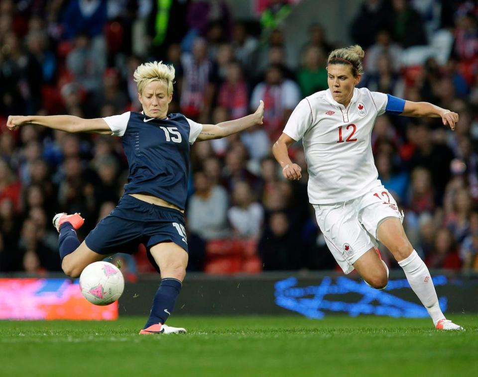 Christine Sinclair, right, and Megan Rapinoe of the U.S. battle during their semifinal match at the 2012 Olympics. The U.S. won the match. (The Associated Press - image credit)