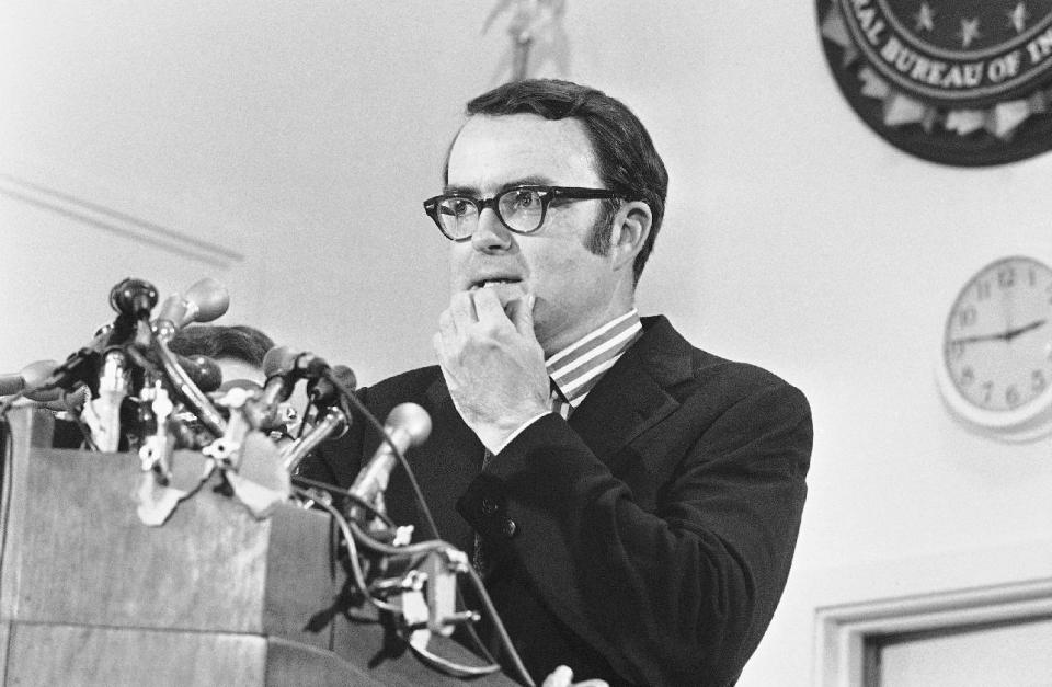 FILE - In this May 15, 1973 file photo, then-acting FBI director William Ruckelshaus pauses during a news conference in Washington. Comparisons to the Nixon-era “Saturday night massacre” were swift after President Donald Trump fired the acting attorney general for refusing to enforce his executive order on immigrants and refugees. In both cases, a dispute between a president and his Justice Department led to an evening maneuver by the president to install an acting attorney general more to his liking. (AP Photo/Charles Gorry)