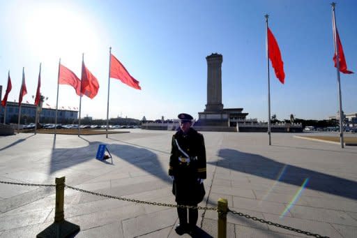 A Chinese paramilitary policeman stands guard on Tiananmen Square during the final session of the National People's Congress (NPC) at the Great Hall of the People in Beijing on March 14, 2012. Chinese lawmakers on March 14 passed into law controversial changes that give police powers to detain some suspects for up to six months in so-called "black jails"