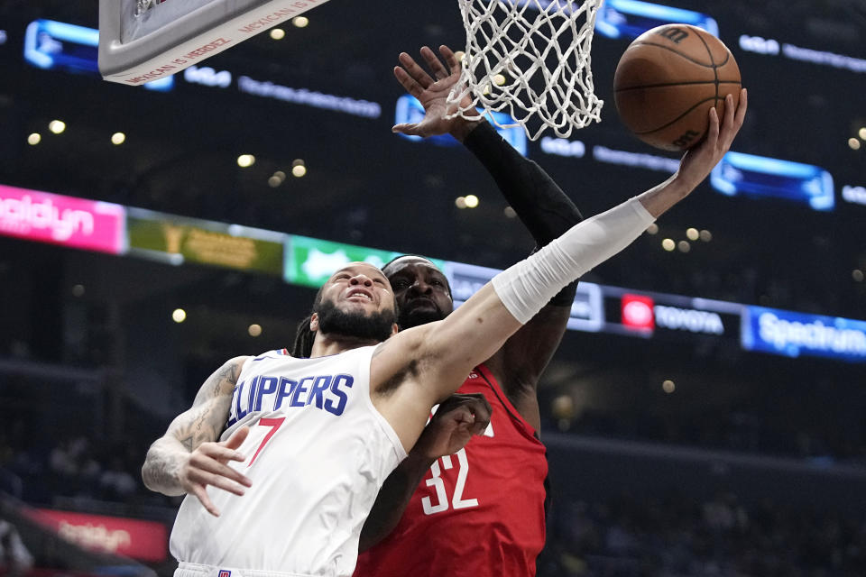 Los Angeles Clippers guard Amir Coffey, left, shoots as Houston Rockets forward Jeff Green defends during the first half of an NBA basketball game Sunday, April 14, 2024, in Los Angeles. (AP Photo/Mark J. Terrill)