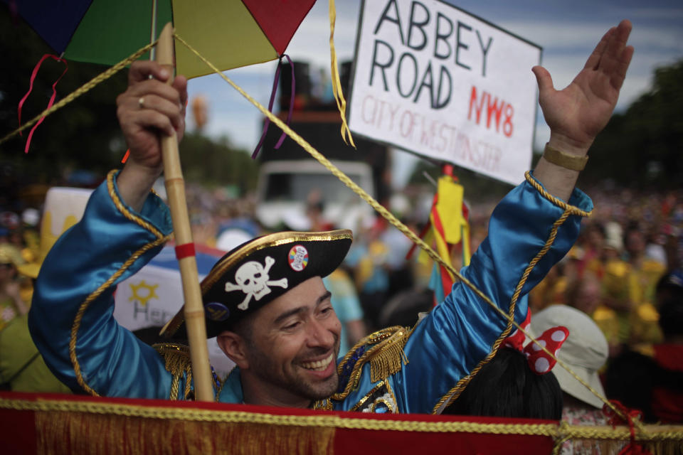 A reveler participates in the Beatles-themed street party, "Sargento Pimenta," Portuguese for "Sergeant Pepper," in the streets of Aterro do Flamengo in Rio de Janeiro, Brazil, Monday Feb. 20, 2012. The group that organizes the party gives the Beatles repertoire a Brazilian tweak, adapting "All My Loving" to the peppy beat of a traditional Carnival "marchinha," or march, and infusing "Hard Day's Night" with a Rio funk sound. (AP Photo/Dado Galdieri)