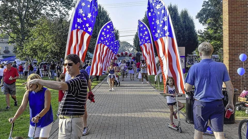 Residents gather last year for the Fourth of July parade, which had an extended route to promote social distancing. This year's parade will follow the same route, but capacity will not be restricted for the rest of the day's festivities.