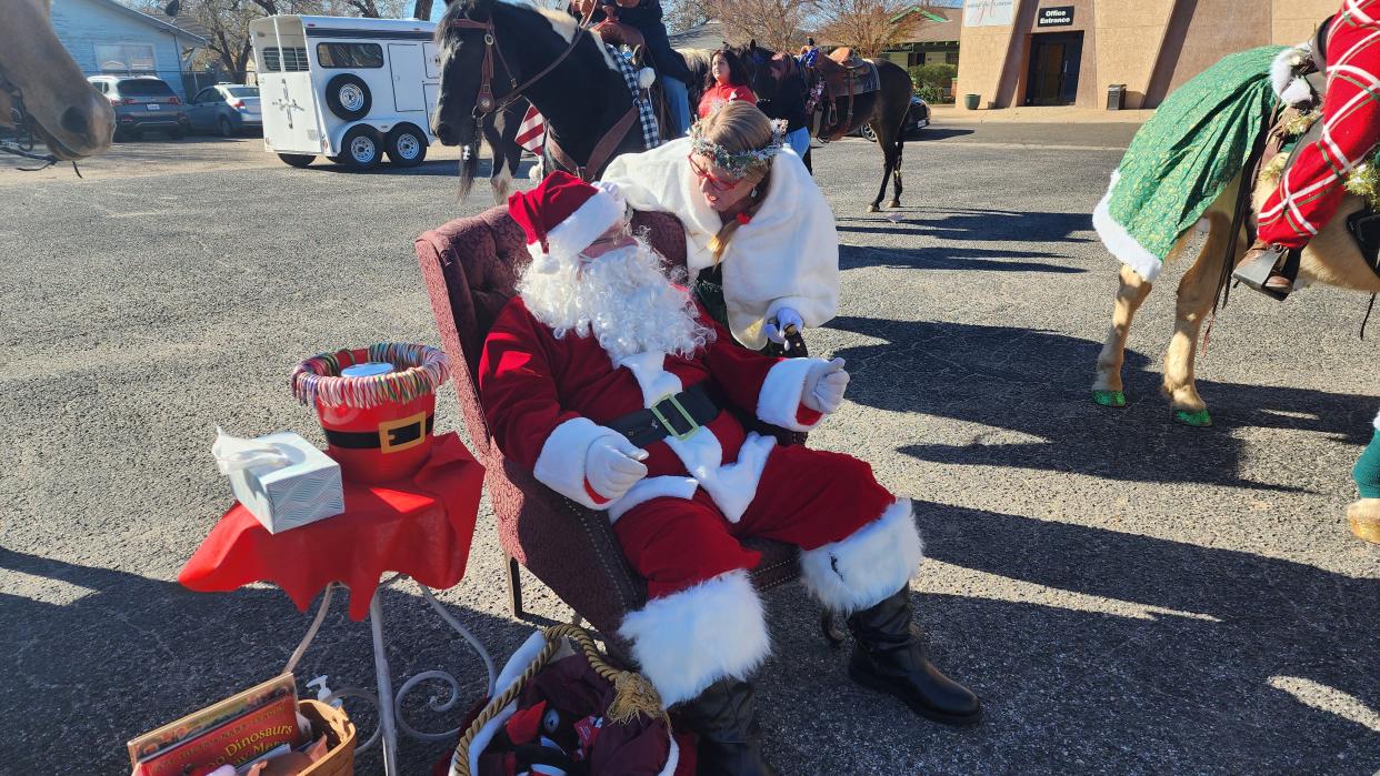 Mrs. Claus has a private word with Santa at the 11th Annual Toy Drive Saturday morning in the historic Route 66 Amarillo District.