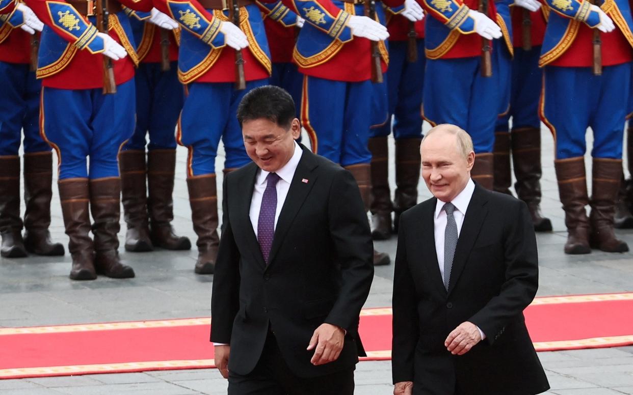 Vladimir Putin and Mongolian President Ukhnaagiin Khurelsukh attend an official welcoming ceremony in Ulaanbaatar on Tuesday