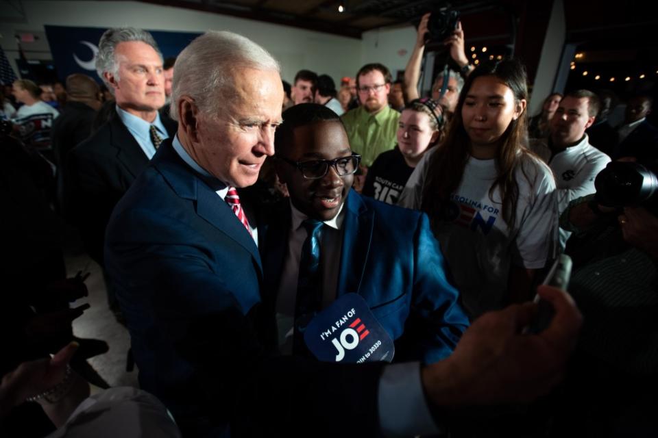 President Joe Biden takes selfies with people in the crowd in South Carolina. (Photo by Sean Rayford/Getty Images)
