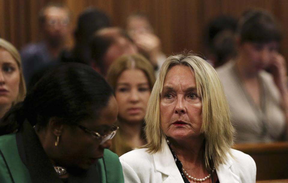 Reeva Steenkamp's mother June (R) reacts, as crime scene photographs are shown during Oscar Pistorius' trial for the murder of his girlfriend Reeva, at the North Gauteng High Court in Pretoria, March 17, 2014. Pistorius is on trial for murdering his girlfriend Reeva Steenkamp at his suburban Pretoria home on Valentine's Day last year. He says he mistook her for an intruder. REUTERS/Siphiwe Sibeko (SOUTH AFRICA - Tags: CRIME LAW SPORT ATHLETICS)