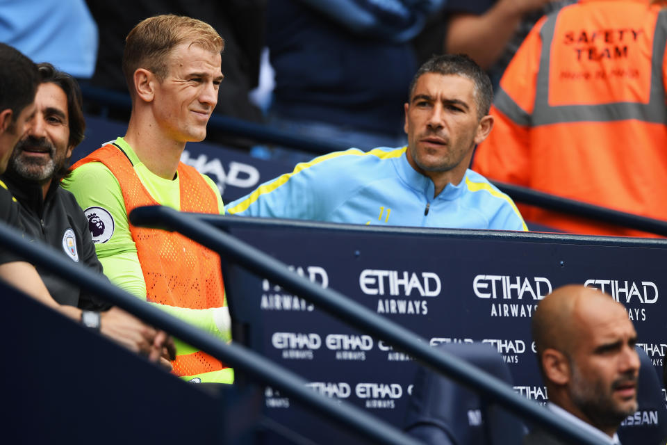 MANCHESTER, ENGLAND - AFormer England international goalkeeper Joe Hart (left) sits on the benches after being dropped by manager Pep Guardiola (bottom right) at Manchester City.UGUST 28:  Joe Hart of Manchester City looks on from the bench with Aleksander Kolorov and manager Josep Guardiola during the Premier League match between Manchester City and West Ham United at Etihad Stadium on August 28, 2016 in Manchester, England.  (Photo by Gareth Copley/Getty Images)