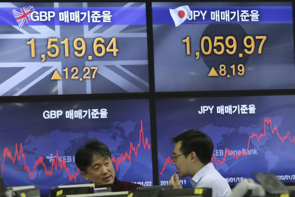 Currency traders work at the foreign exchange dealing room of the KEB Hana Bank headquarters in Seoul, South Korea, Wednesday, Jan. 22, 2020. Shares advanced in early Asian trading after a slide in U.S. stocks Tuesday as a virus outbreak in China rattled global markets. (AP Photo/Ahn Young-joon)