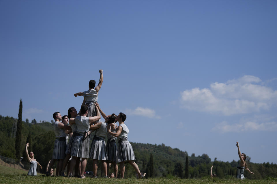 Performers, who will take part in the flame lighting ceremony for the Paris Olympics, join a rehearsal at Ancient Olympia site, Greece, Sunday, April 14, 2024. Every two years, a countdown to the Olympic games is launched from its ancient birthplace with a flame lighting ceremony in southern Greece at Ancient Olympia. The event is marked with a performance by dancers who assume the role of priestesses and male companions, their movement inspired by scenes on millennia-old artwork. (AP Photo/Thanassis Stavrakis)