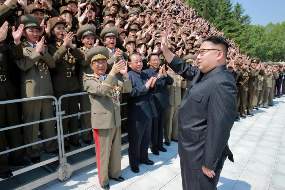 North Korean leader Kim Jong Un waves to scientists and technicians (file photo) (REUTERS)