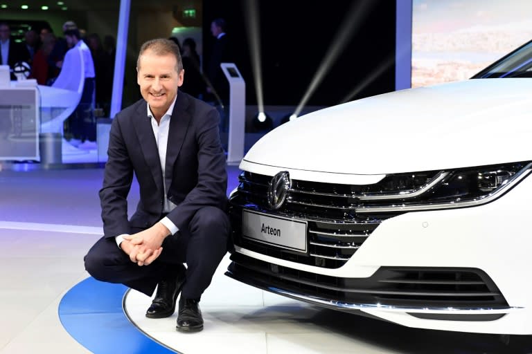 Herbert Diess, chairman of the Volkswagen brand, poses next to the new Arteon during the first press day of the the Geneva International Motor Show on March 7, 2017 in Geneva