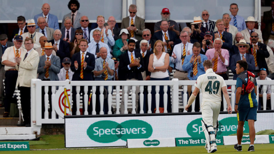 Steve Smith, pictured here walking off the field after the scary blow. (Photo by ADRIAN DENNIS/AFP/Getty Images)