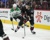 Arizona Coyotes' Ryan Dzingel (10) skates away from Dallas Stars' Joel Kiviranta (25) during the first period of an NHL hockey game Saturday, Nov. 27, 2021, in Glendale, Ariz. (AP Photo/Darryl Webb)