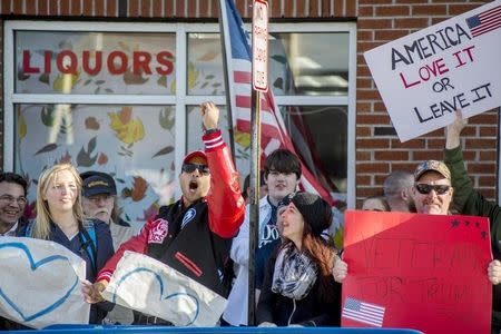 Demonstrators in opposition to U.S. Republican presidential candidate Donald Trump rally near his campaign event in Patchogue, New York April 14, 2016. REUTERS/Johnny Milano